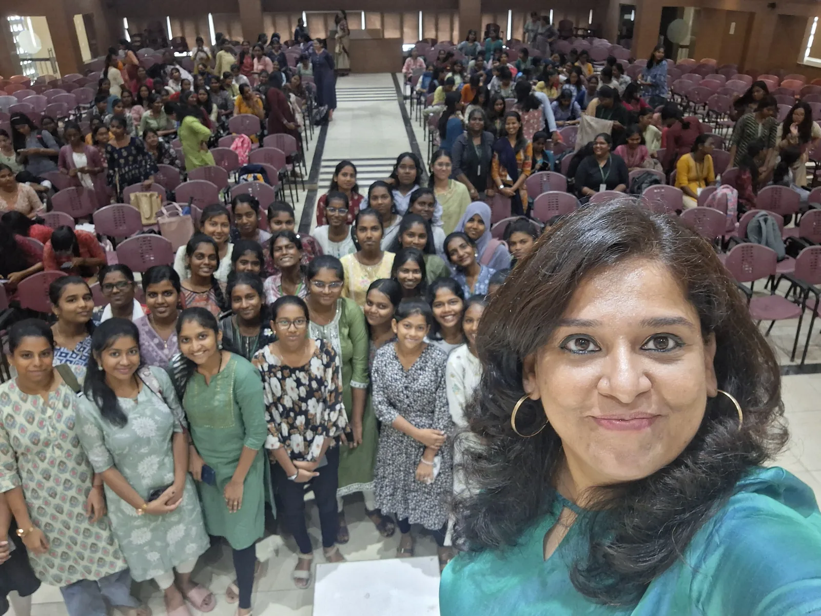 Meera Grover with a full auditorium of attendees at a session
