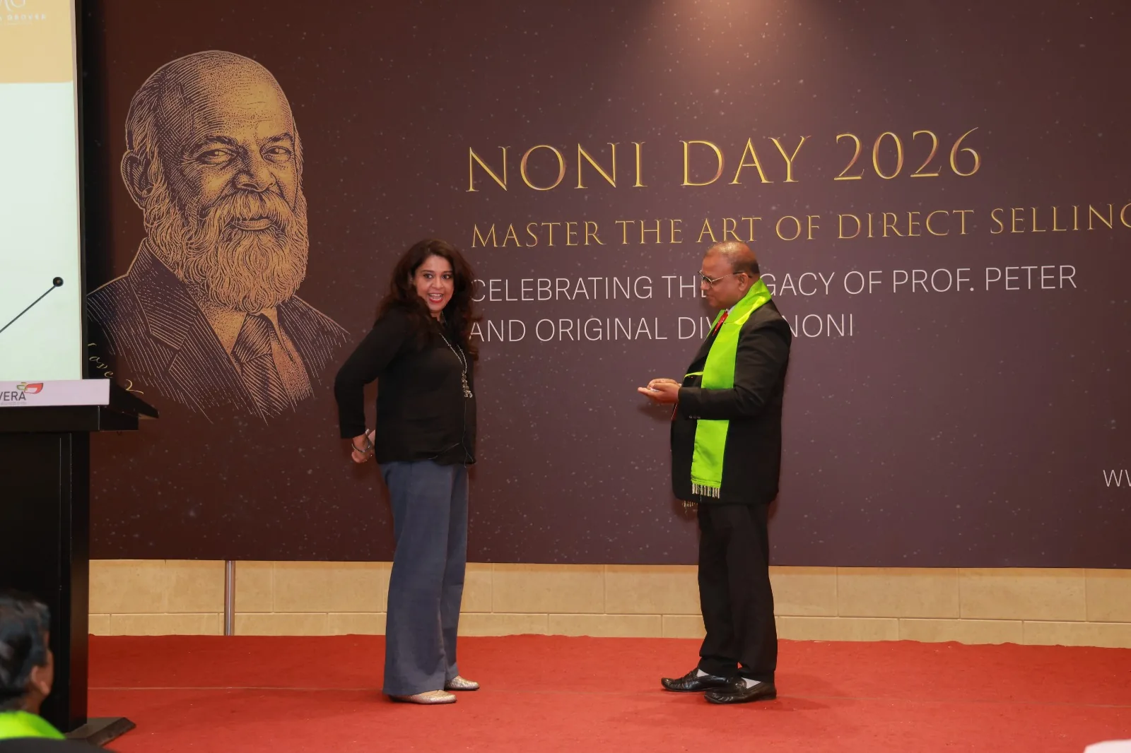 Meera Grover presenting on stage at NONI DAY 2026