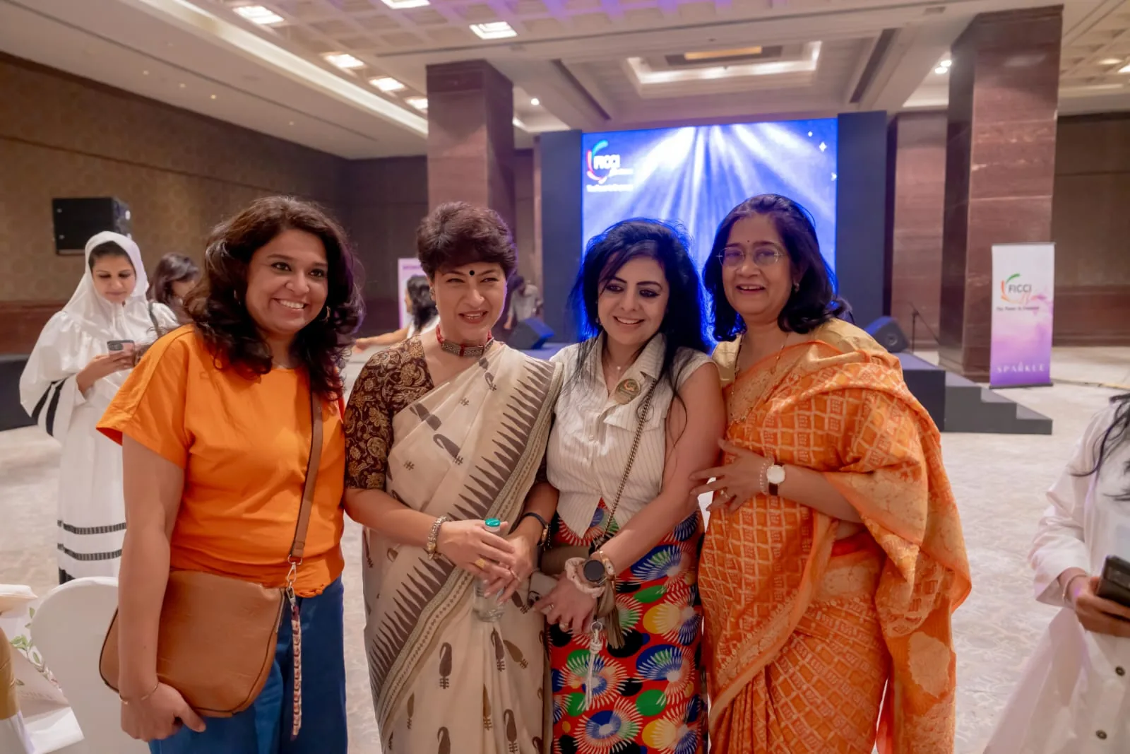 Meera Grover with a group at an evening event
