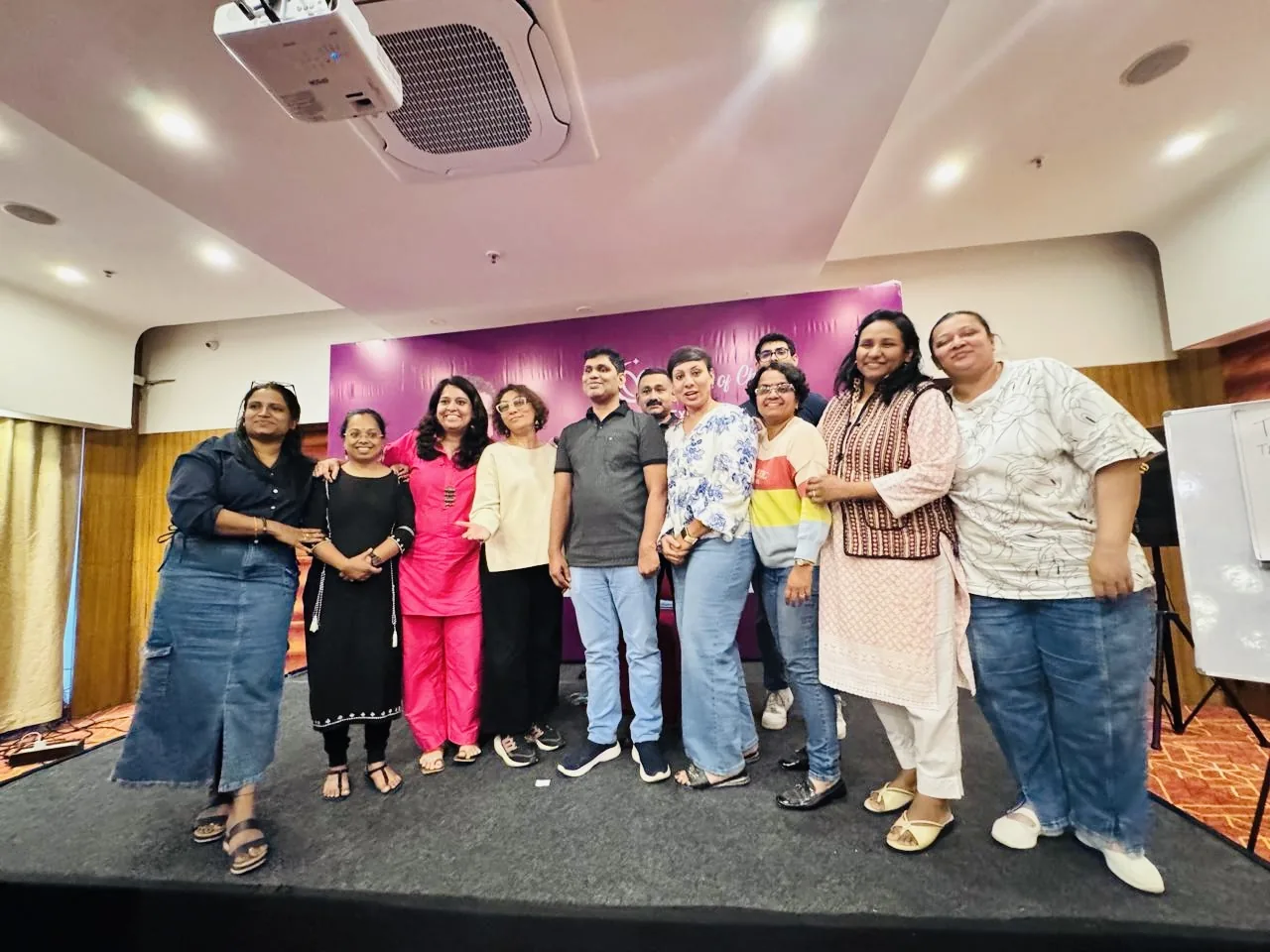 Meera Grover on stage with a group of speakers